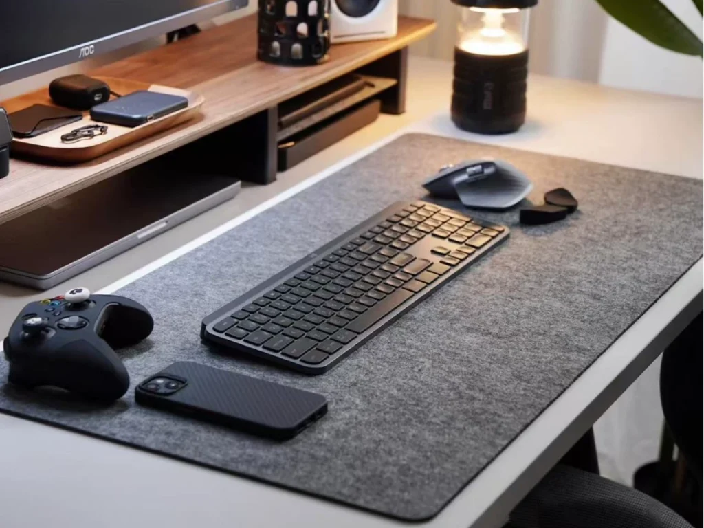 XXL anthracite gray mouse pad on minimalist desk with keyboard and speaker