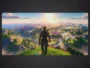Grand tapis de souris gamer affichant un paysage coloré de Fortine avec un personnage de dos observant le coucher de soleil.